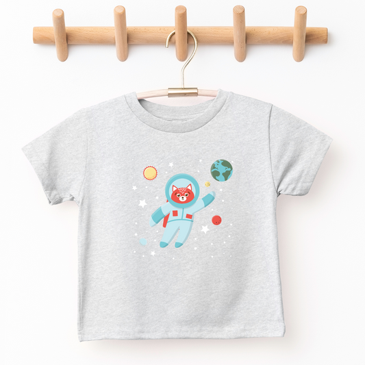 kid's graphic tee illustrated with cat in astronaut suit illutration. Around cat is image of Earth, sun and stars
